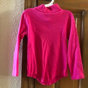 Pink mock turtleneck long sleeved shirt.